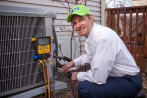 ABC technician operating on outdoor HVAC unit