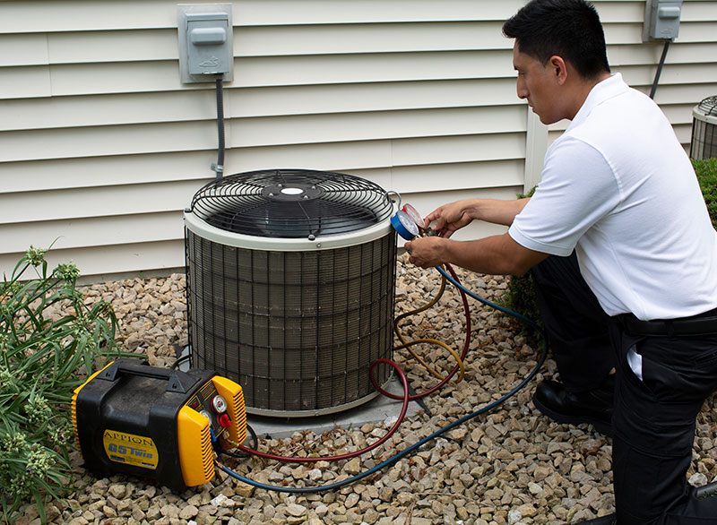 HVAC contractor performing air conditioner inspection