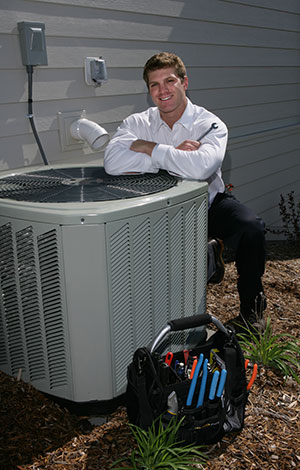 HVAC contractor smiling and completing AC inspection