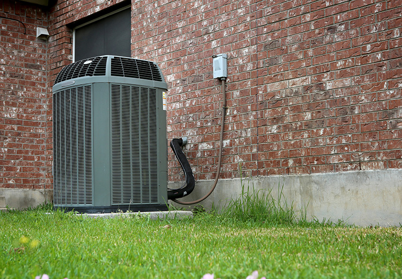 air conditioning unit in grass
