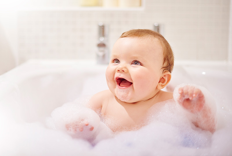baby smiling in bubble bath