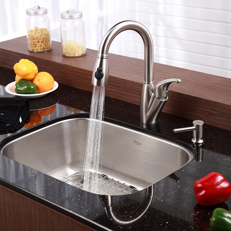 brushed silver kitchen sink with running water
