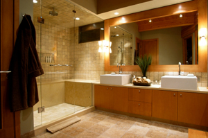 A newly renovated bathroom with wooden cabinets and a standing shower