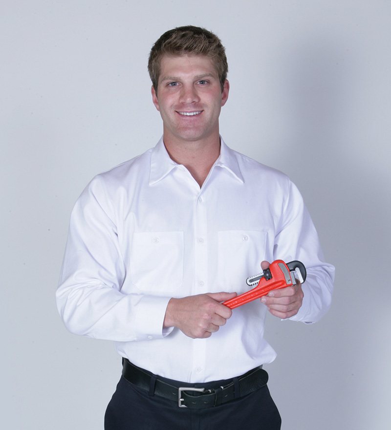 plumber smiling in white button up with tool