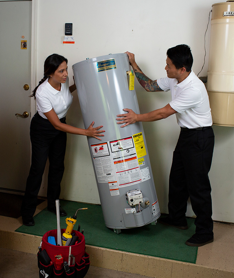 two plumbers installing a water heater