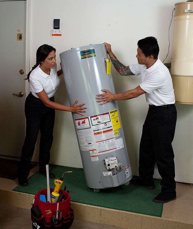 2 expert plumbers installing a new water heater in a home