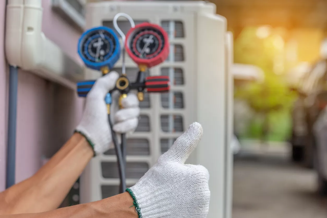 Close up of Air Conditioning repairman fixing air conditioning system