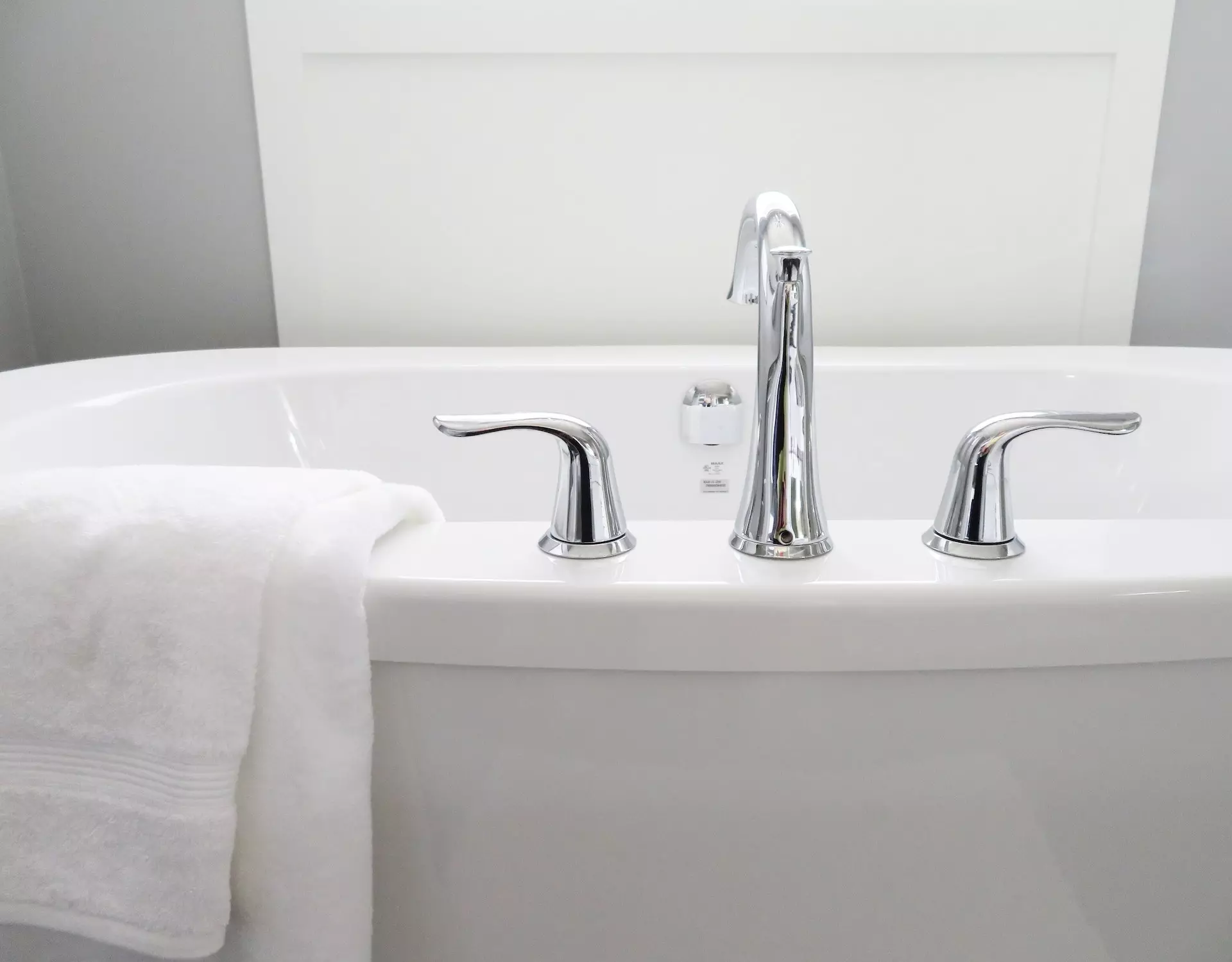 bathtub close up with silver fixtures and towel