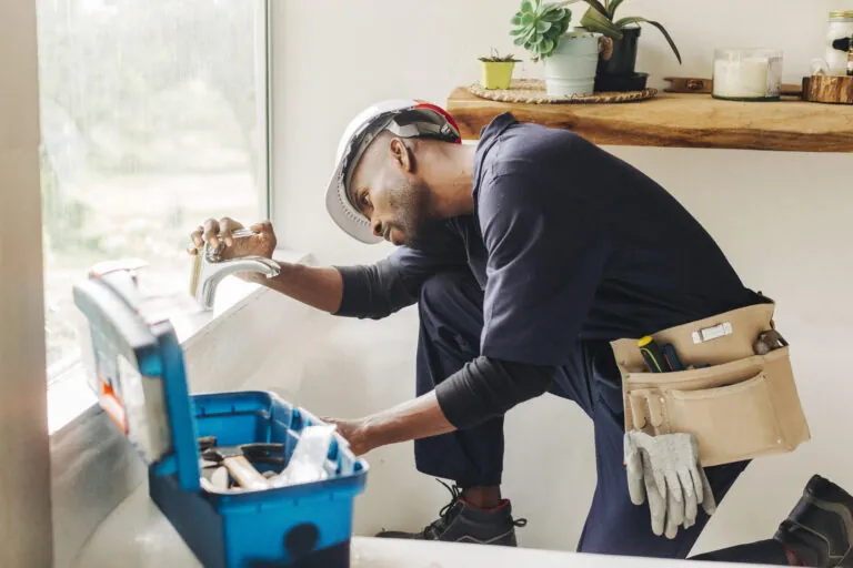 Plumber installing new bathroom fixtures